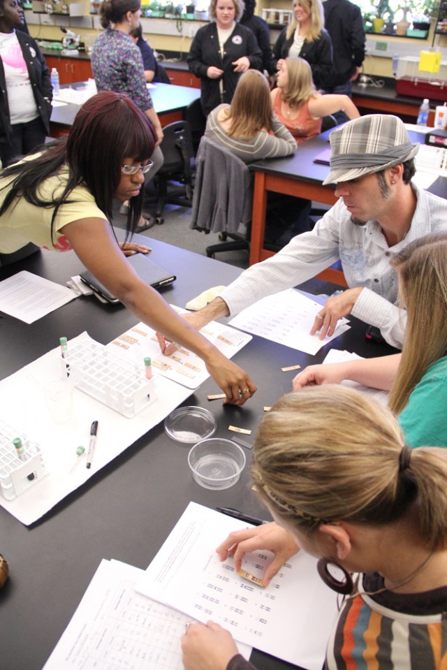 Genetics students practice mapping karyotypes, as they will do with their own DNA once their blood samples are processed.